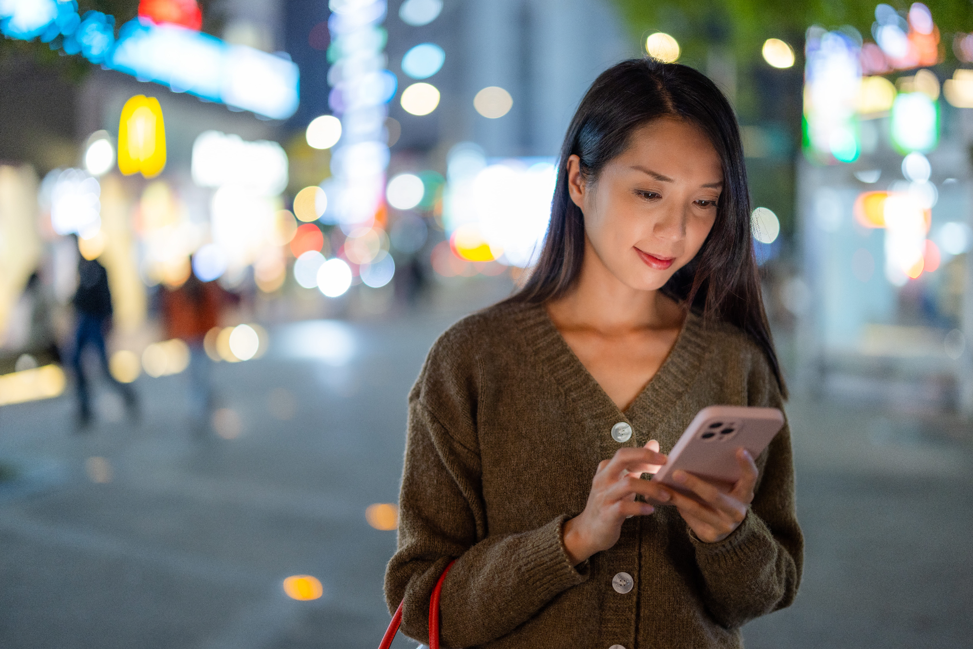Asian woman using smartphone in city